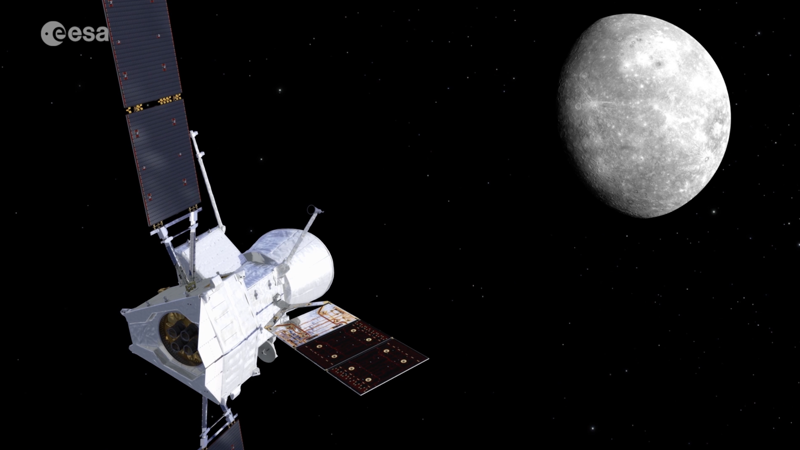 The BepiColombo composite spacecraft - ESA's Mercury Planetary Orbiter (MPO) at the base with its single solar array extended, JAXA's Mio (Mercury Magnetospheric Orbiter) sheltered inside the white MOSIF sunshield on top, and the Mercury Transfer Module's large rectangular solar wing visible behind the stack - approaches a half-lit Mercury against a black starfield. Credit: ESA / ESA Multimedia image (24 June 2026).