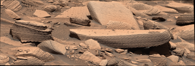 Layered beige Martian rocks at the Jawbone Canyon site in Gale crater, photographed by NASA's Curiosity rover on Sol 4391 (December 12, 2024), showing the stacked wind ripple laminations interpreted as supercritical climbing wind ripple strata.