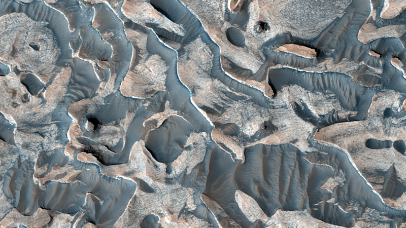 Layered bedrock in a crater within Arabia Terra on Mars, captured by HiRISE aboard Mars Reconnaissance Orbiter and released September 28 2026.